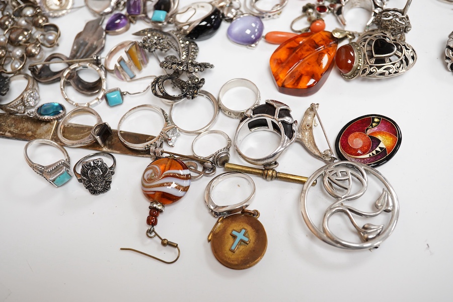 A quantity of assorted silver and costume jewellery including a Georg Jensen style brooch, a graduated coral bead necklace, 56cm, gross weight 35 grams, pair of coral drop earrings, a George V silver combination latter o